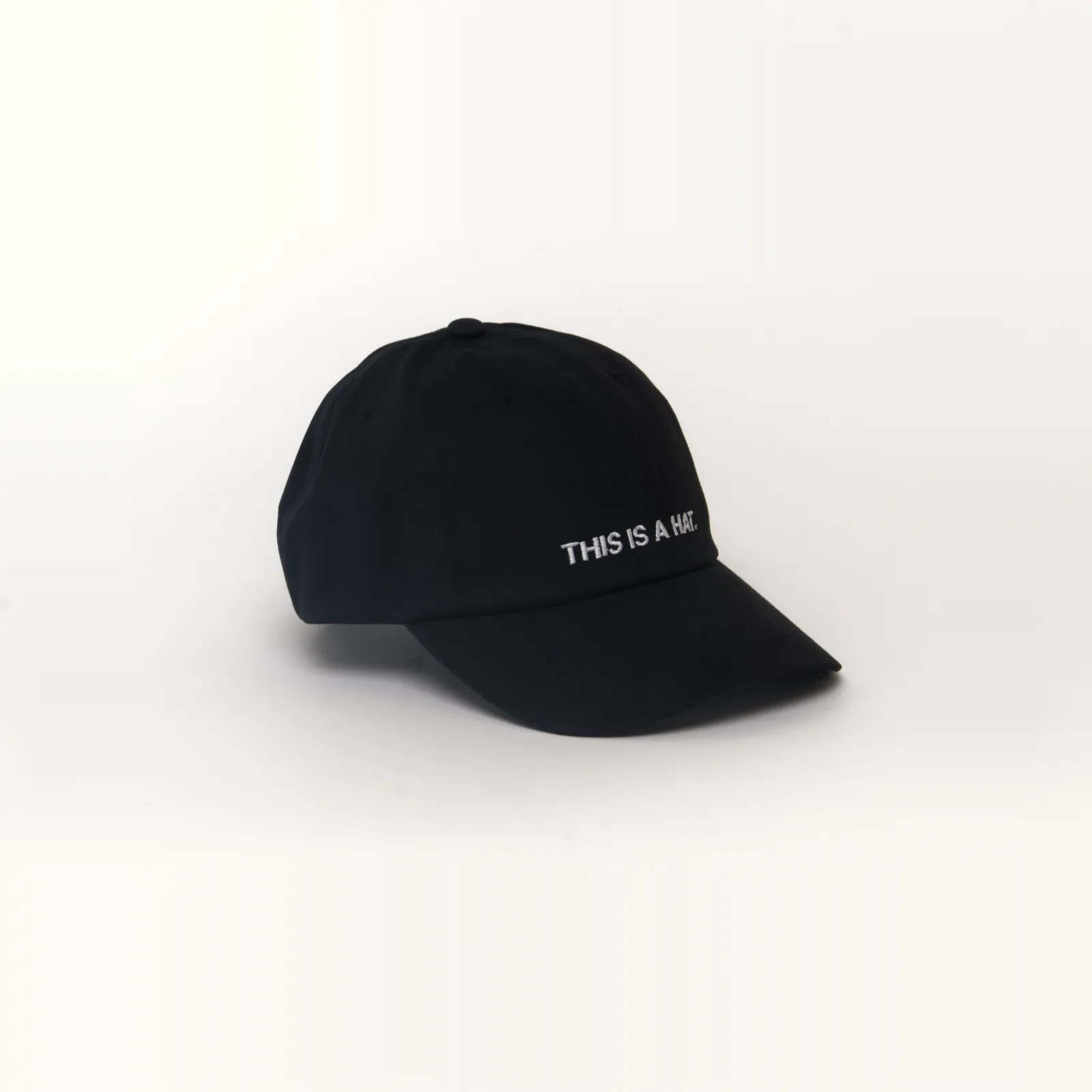 Black hat that says THIS IS A HAT, 3/4 view