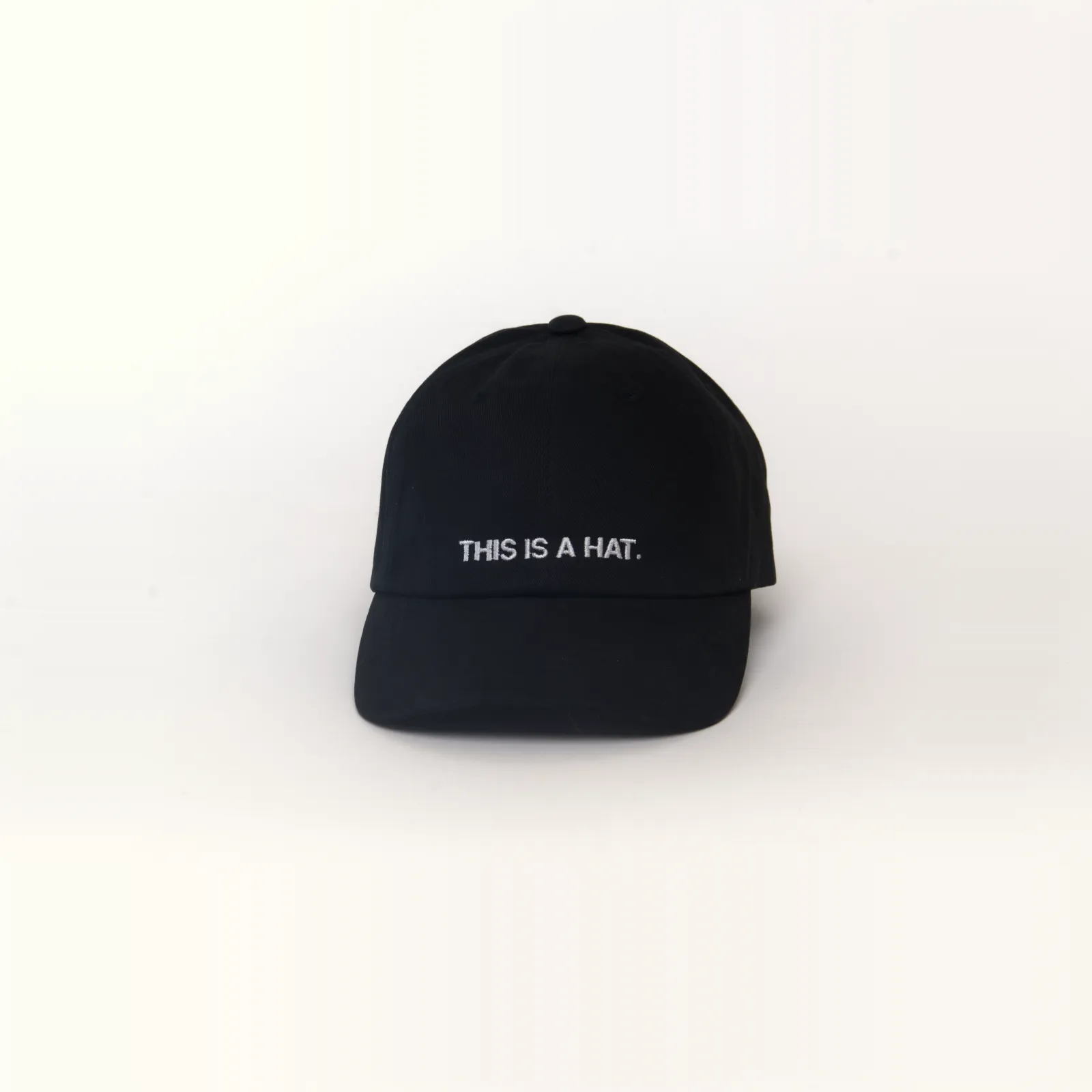 Black hat that says THIS IS A HAT, front view